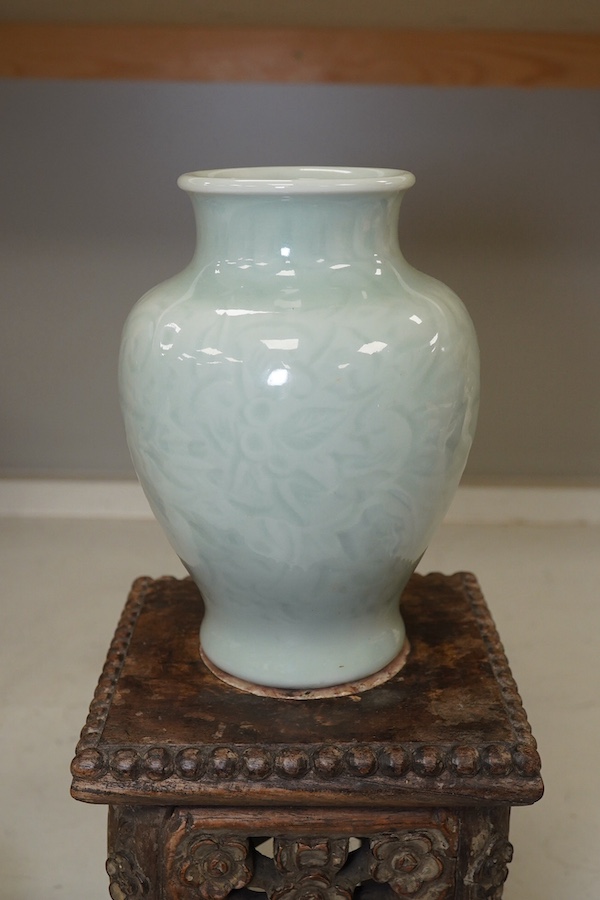 A Chinese celadon glazed vase, marble inset hardwood stand, 18th century Chinese Export blue and white plate, pot and cover and a circular wood stand, tallest 20cm. Condition - fair to good